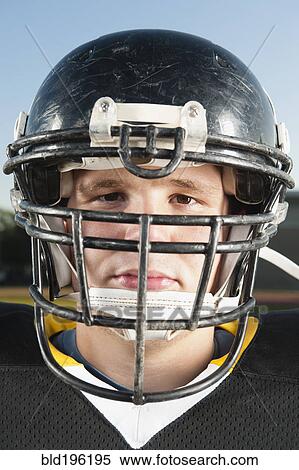 Stock Photography - Serious Caucasian football player in helmet. Fotosearch