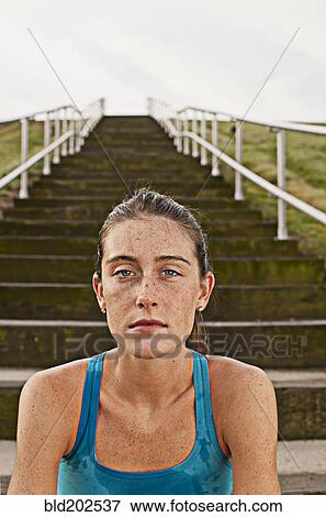 Serious Caucasian woman sitting on steps View Large Photo Image Stock Photo - Serious Caucasian woman sitting on steps. Fotosearch
