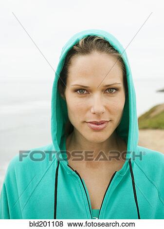Stock Photo - Serious Caucasian woman wearing hooded jacket. Fotosearch
