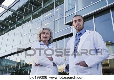 Stock Photograph - Serious doctors standing outdoors. Fotosearch