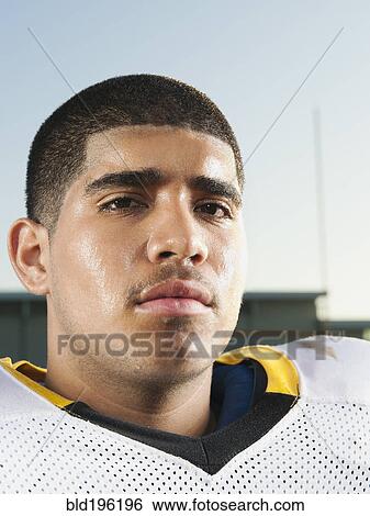 Stock Photograph - Serious Hispanic football player. Fotosearch