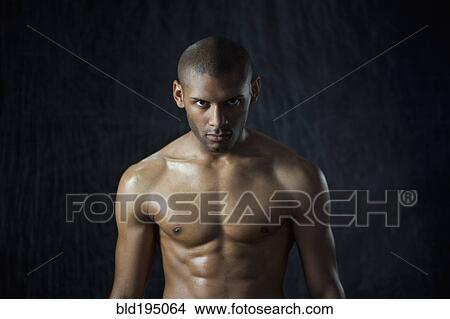 Serious Hispanic man with bare chest View Large Photo Image Picture - Serious Hispanic man with bare chest. Fotosearch