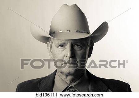 Stock Image - Serious man wearing cowboy hat. Fotosearch