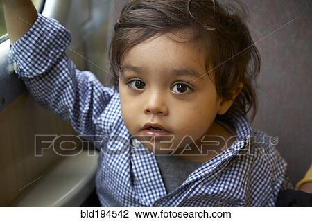 Stock Image - Serious mixed race boy. Fotosearch