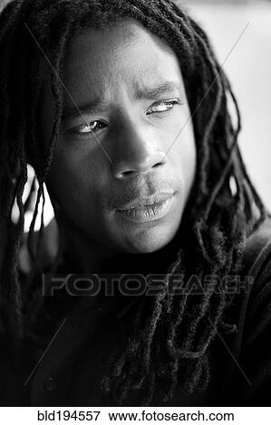 Stock Photo - Serious mixed race man with dreadlocks. Fotosearch