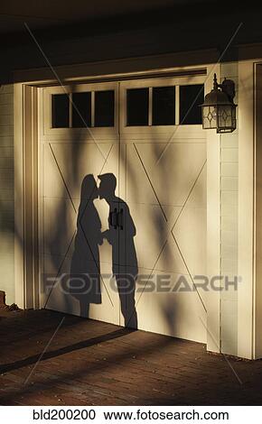 Shadow on garage of couple kissing View Large Photo Image Stock Image - Shadow on garage of couple kissing. Fotosearch