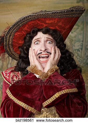Stock Image - Shocked actor dressed in old-fashioned costume on stage. Fotosearch