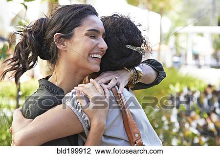 Stock Image - Sisters hugging. Fotosearch