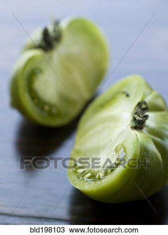Stock Image - Sliced green tomato. Fotosearch