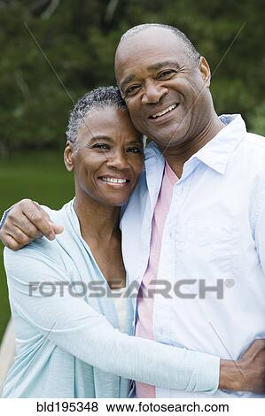 Smiling African American couple hugging View Large Photo Image Stock Photo - Smiling African American couple hugging. Fotosearch