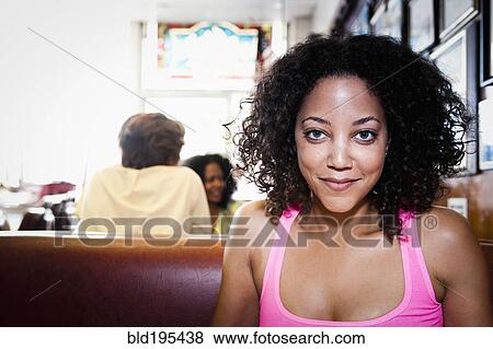 Stock Photo - Smiling African American woman in diner. Fotosearch