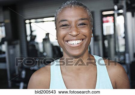 Smiling African American woman in health club View Large Photo Image Stock Image - Smiling African American woman in health club. Fotosearch