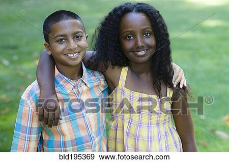 Stock Photo - Smiling boy and girl hugging. Fotosearch