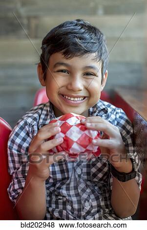 Smiling boy holding burger View Large Photo Image Stock Photo - Smiling boy holding burger. Fotosearch