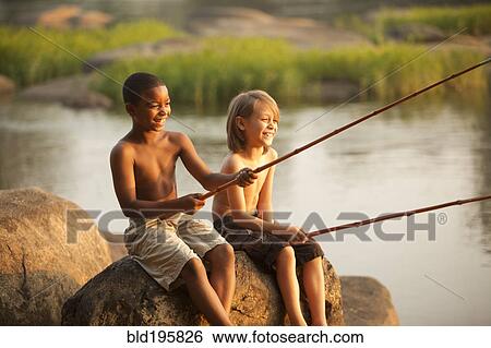 Stock Photograph - Smiling boys fishing together. Fotosearch