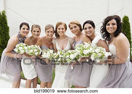 Stock Photo - Smiling bridal party standing with bride. Fotosearch
