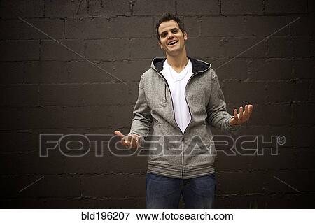 Stock Photo - Smiling Caucasian man shrugging. Fotosearch