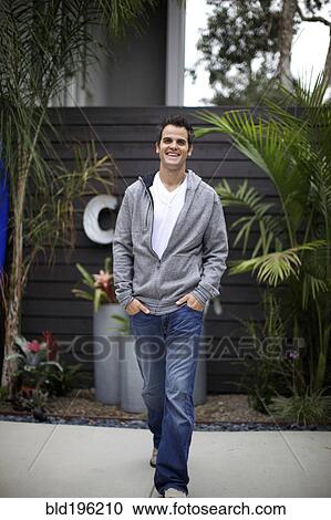 Smiling Caucasian man walking outdoors View Large Photo Image Stock Image - Smiling Caucasian man walking outdoors. Fotosearch