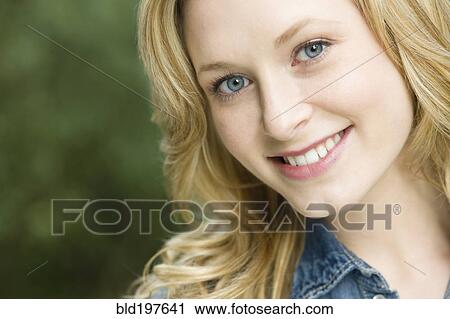 Stock Image - Smiling Caucasian woman outdoors. Fotosearch