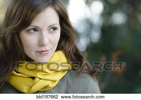 Stock Image - Smiling Caucasian woman outdoors. Fotosearch