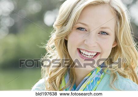 Stock Photo - Smiling Caucasian woman outdoors. Fotosearch
