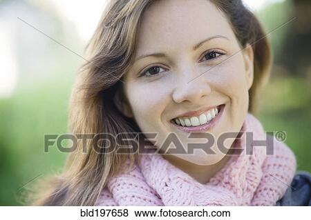 Stock Photo - Smiling Caucasian woman outdoors. Fotosearch