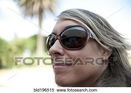 Smiling Caucasian woman wearing sunglasses View Large Photo Image Stock Photography - Smiling Caucasian woman wearing sunglasses. Fotosearch