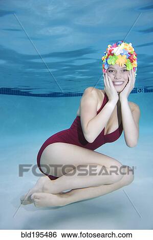 Smiling Caucasian woman wearing vintage bathing suit and cap underwater View Large Photo Image Stock Photograph - Smiling Caucasian woman wearing vintage bathing suit and cap underwater. Fotosearch