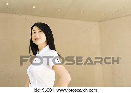 Stock Image - Smiling Chinese businesswoman in office. Fotosearch