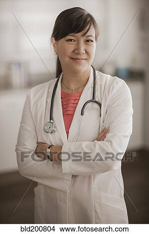 Smiling Chinese doctor View Large Photo Image Picture - Smiling Chinese doctor. Fotosearch