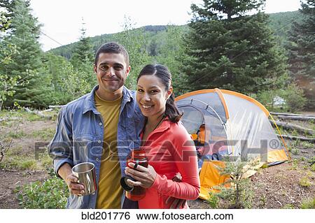 Smiling couple camping together View Large Photo Image Stock Photograph - Smiling couple camping together. Fotosearch