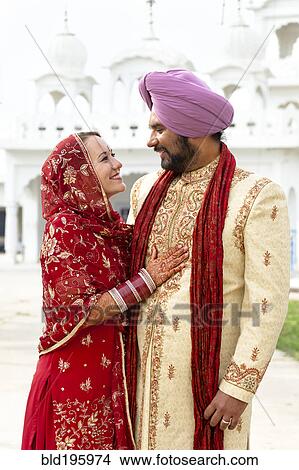 Picture - Smiling couple in traditional Indian clothing. Fotosearch