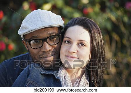 Smiling couple standing outdoors View Large Photo Image Stock Photo - Smiling couple standing outdoors. Fotosearch