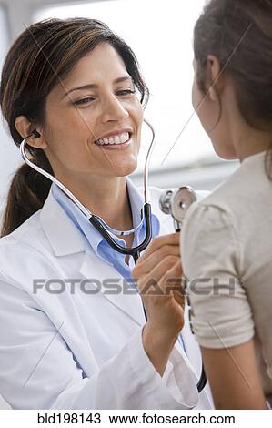 Smiling Doctor examining patient View Large Photo Image Stock Image - Smiling Doctor examining patient. Fotosearch