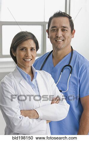 Stock Image - Smiling doctors standing together. Fotosearch