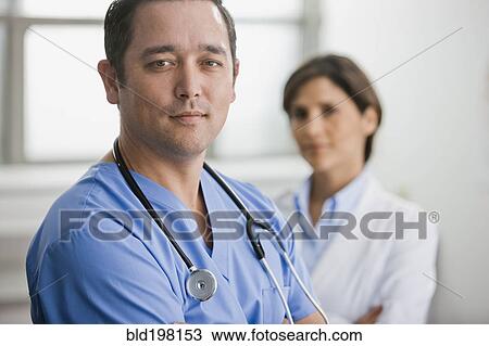 Stock Image - Smiling doctors standing together. Fotosearch