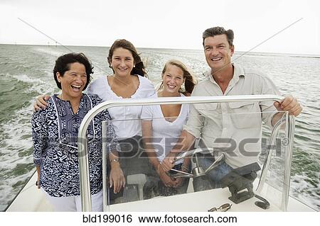 Stock Photograph - Smiling family boating outdoors. Fotosearch