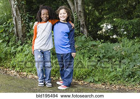 Picture - Smiling friends in park. Fotosearch