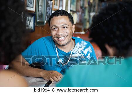 Smiling friends sitting in diner View Large Photo Image Stock Photo - Smiling friends sitting in diner. Fotosearch
