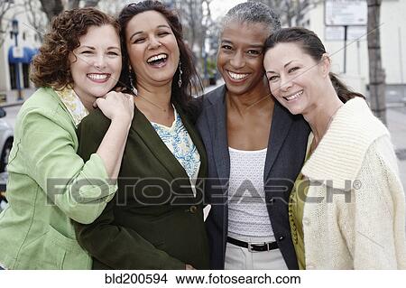 Picture - Smiling friends standing together. Fotosearch