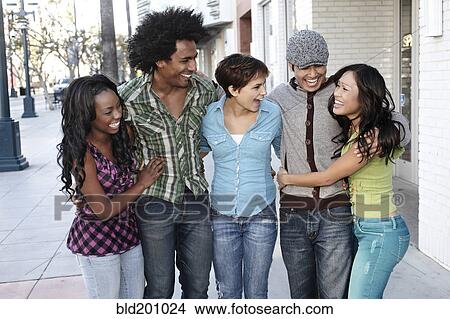 Smiling friends standing together hugging View Large Photo Image Picture - Smiling friends standing together hugging. Fotosearch