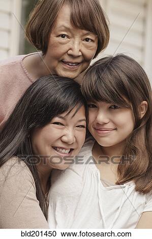 Stock Image - Smiling grandmother, mother and daughter. Fotosearch