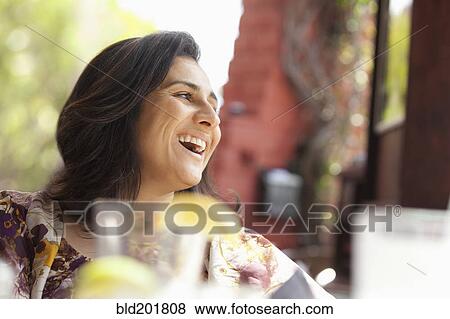 Smiling Hispanic woman in restaurant View Large Photo Image Stock Photo - Smiling Hispanic woman in restaurant. Fotosearch