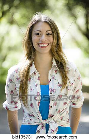Smiling Hispanic woman outdoors View Large Photo Image Stock Image - Smiling Hispanic woman outdoors. Fotosearch