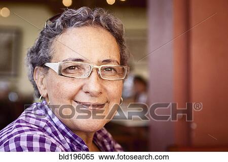Smiling Hispanic woman wearing eyeglasses View Large Photo Image Stock Photography - Smiling Hispanic woman wearing eyeglasses. Fotosearch