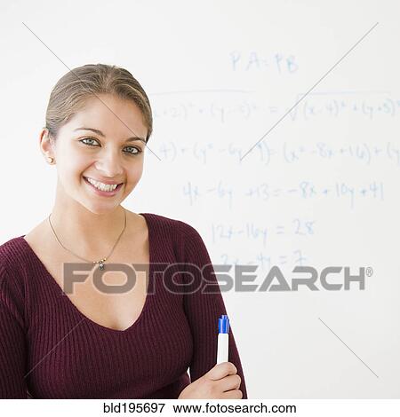 Smiling Indian student next to whiteboard in classroom View Large Photo Image Stock Photo - Smiling Indian student next to whiteboard in classroom. Fotosearch
