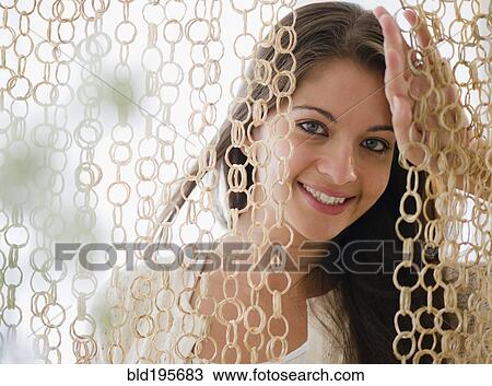 Smiling Indian woman behind modern curtain View Large Photo Image Stock Image - Smiling Indian woman behind modern curtain. Fotosearch
