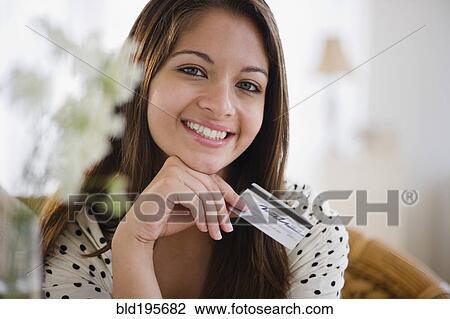 Smiling Indian woman holding credit card View Large Photo Image Stock Image - Smiling Indian woman holding credit card. Fotosearch