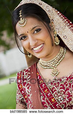 Stock Photography - Smiling Indian woman in traditional wedding clothing. Fotosearch