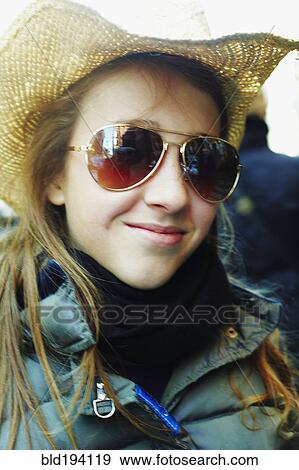 Stock Photo - Smiling Italian girl wearing cowboy hat and sunglasses. Fotosearch